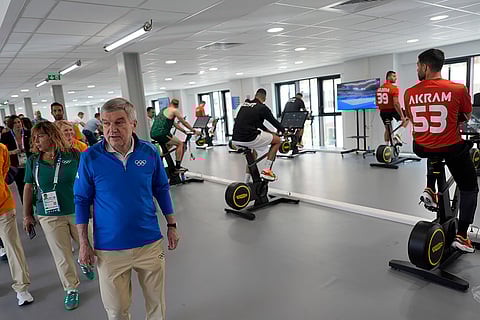 Thomas Bach tours the gym at the Olympic Village
